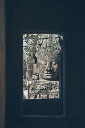 Shabby face on old temple