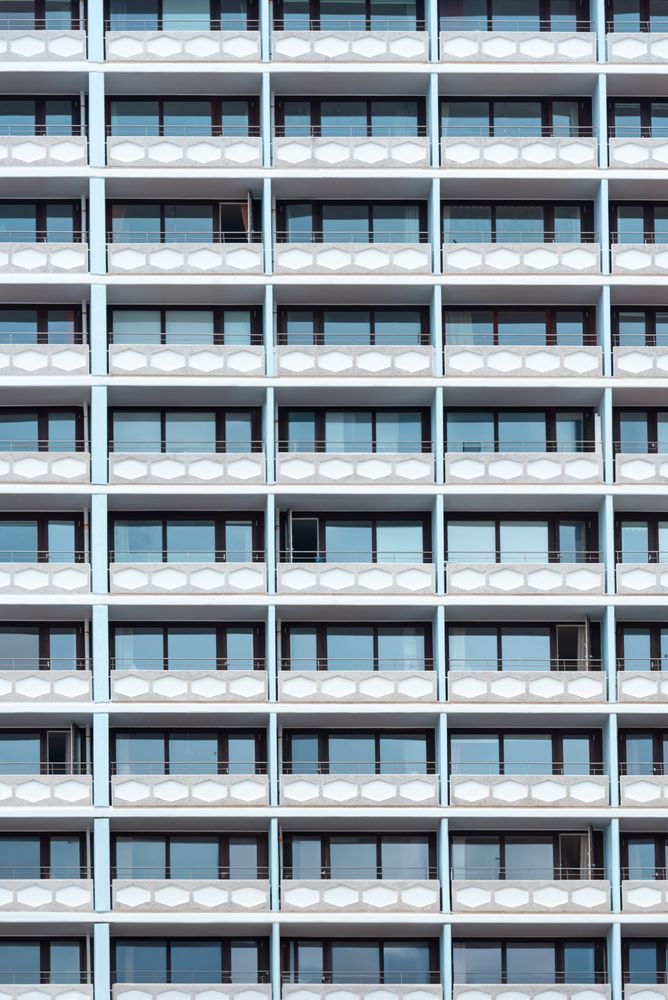 Hotel building with a lot of balconies and windows, vertical