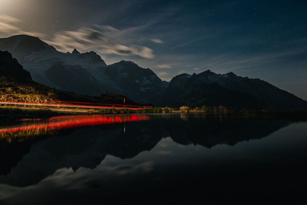 Red lit shore and water surface in mountains
