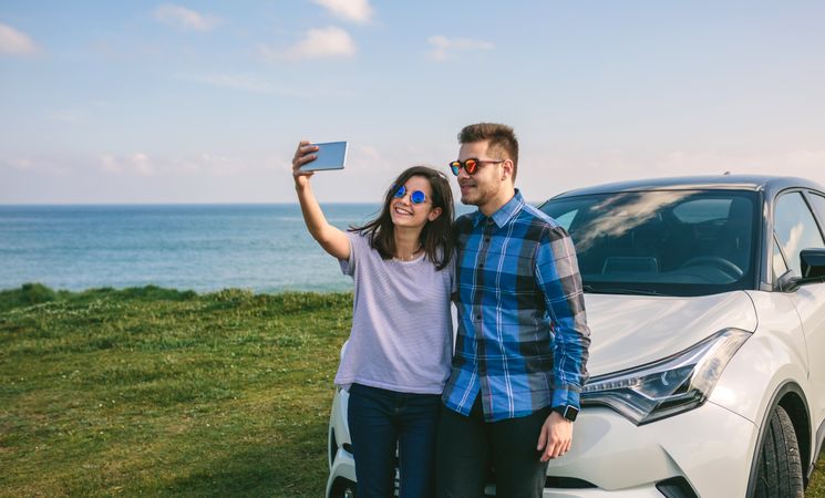 Young couple doing a selfie on the car