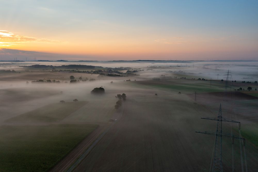Sunrise aerial view in a german village on a foggy morning