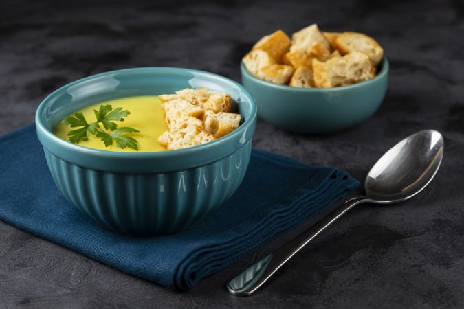 Bowl with onion soup and croutons on the table.