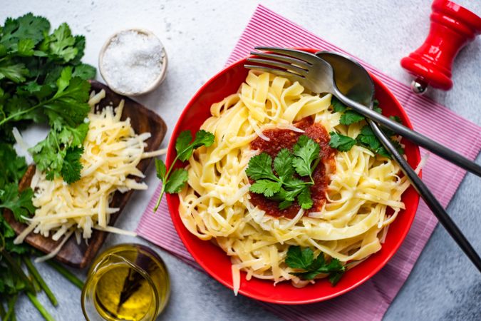 Pasta with cheese & tomato sauce on counter with copy space