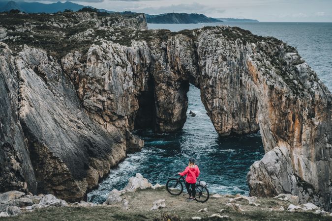 Female bicyclist on rocks