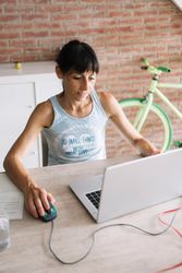 Calm woman working at laptop at home