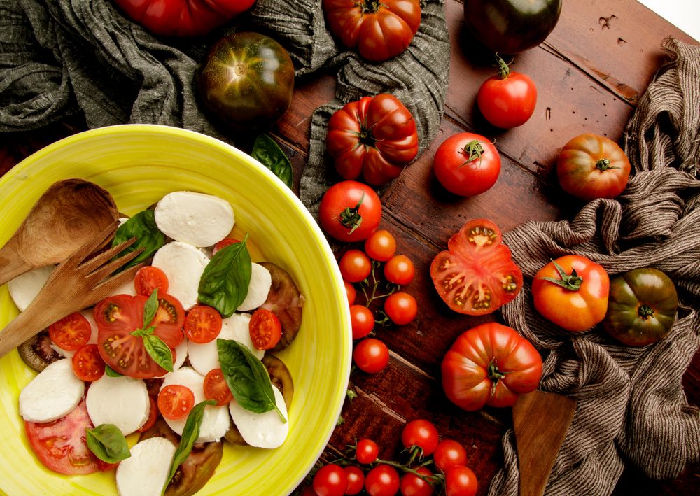 Tomatoes and napkins near bowl with salad