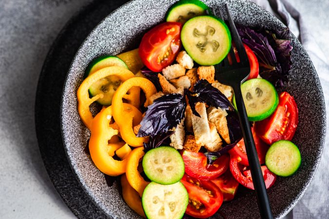 Top view of healthy gourmet salad with tomatoes, cucumber and yellow peppers