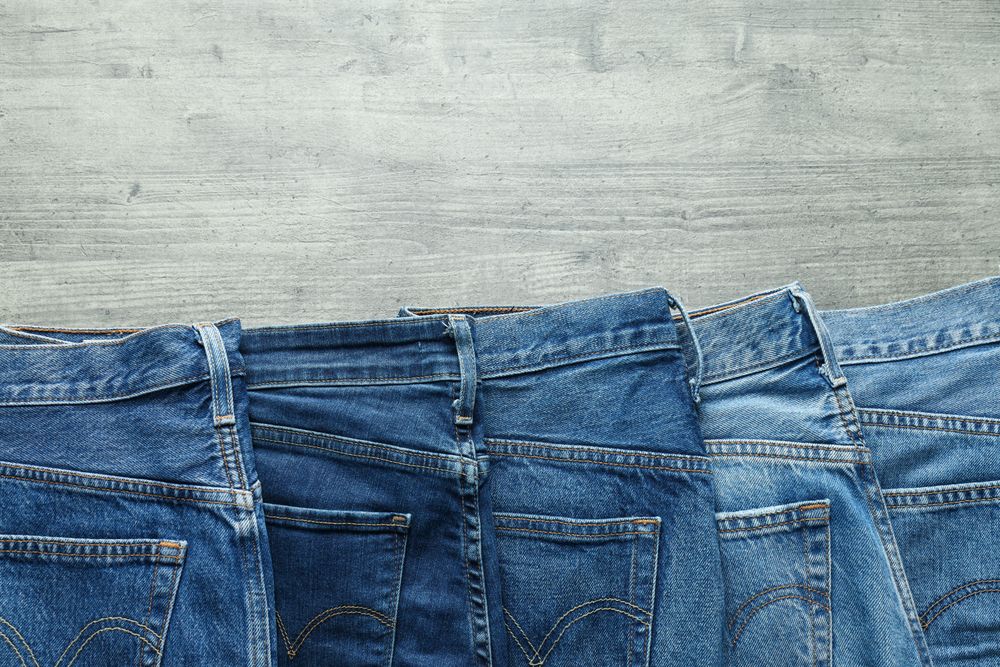 Folded jeans on a wooden background
