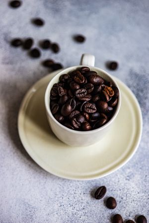 Coffee beans in cream cup