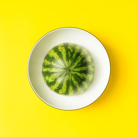 Watermelon on a bowl with yellow background
