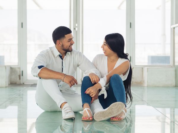 Man embracing smiling woman with love and tenderness