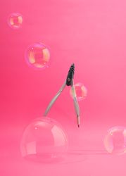 School compass suspended with bubbles