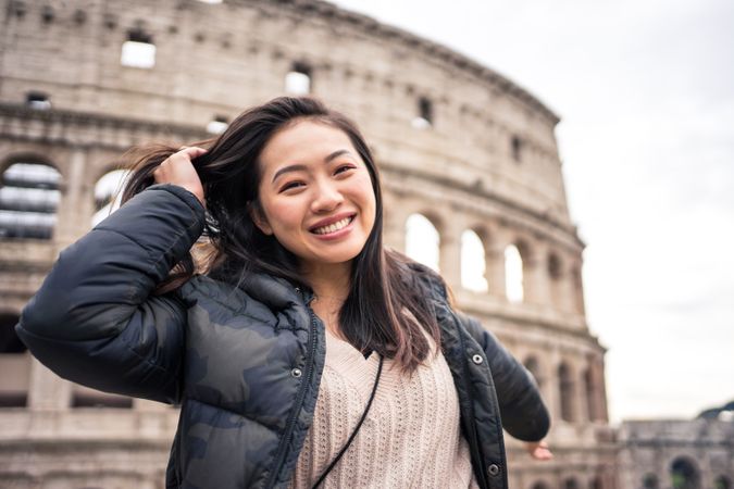 Cheerful Asian traveler outside famous landmark
