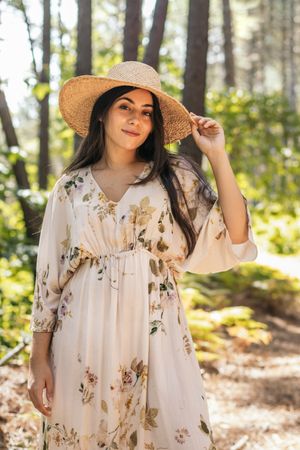 Woman with a straw hat in the forest