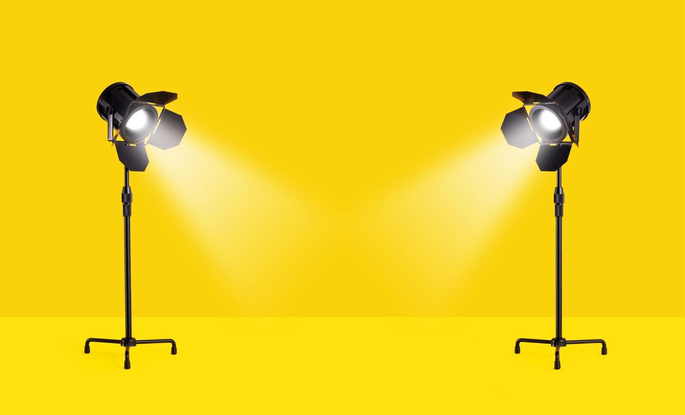 Studio lamps over yellow background