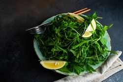 Fresh arugula salad with fresh lemon slices