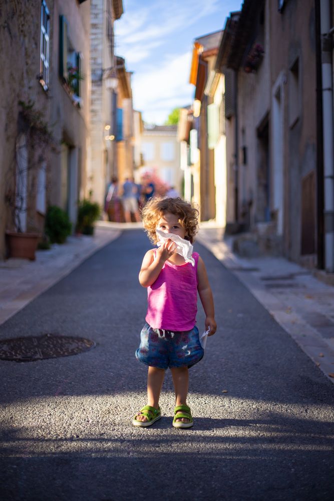 Smiling child standing on street