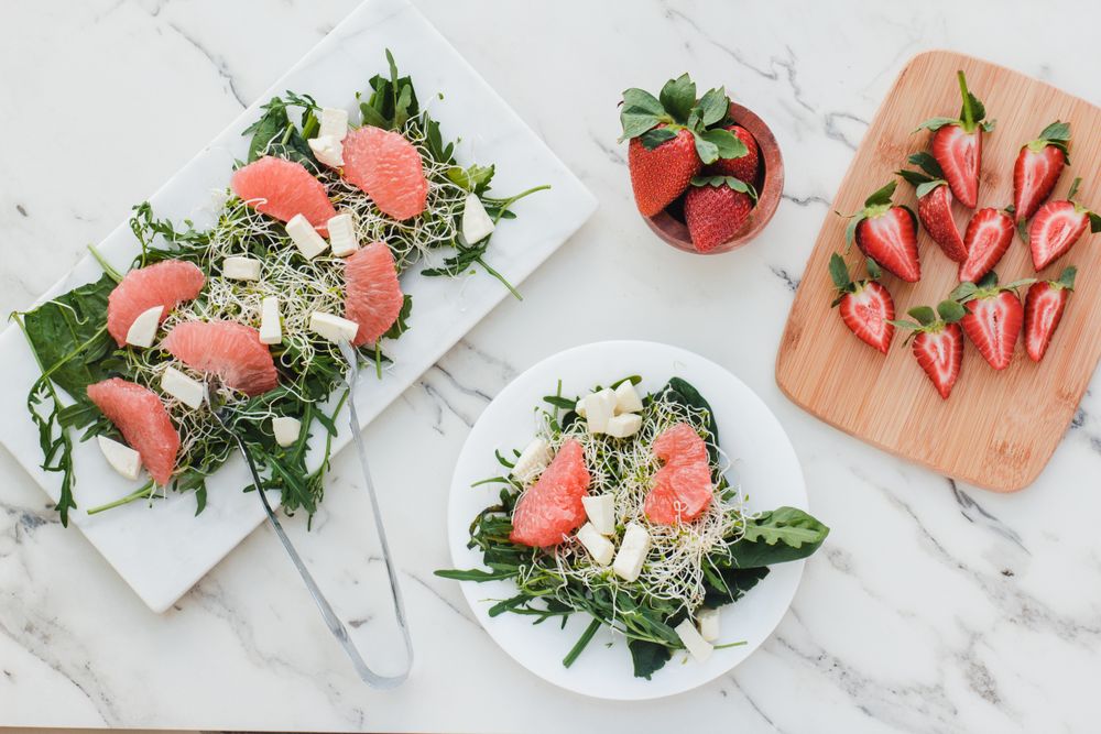 Strawberry, grapefruit and rocket salad on bowl