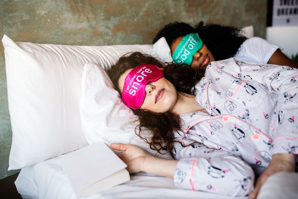 Females relaxed sleeping in bed with blindfold at home