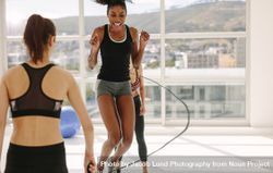 Women enjoying jumping rope workout at gym 0V6O3O