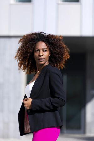 Black female turning around while standing outside of building