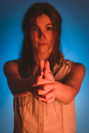 woman with piercing in nose making gun gesture