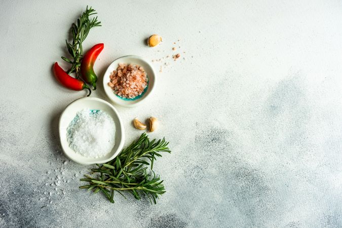 Rosemary with salt and pepper on marble counter