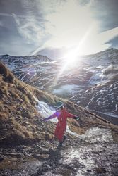 Kid balancing on stones in mountains