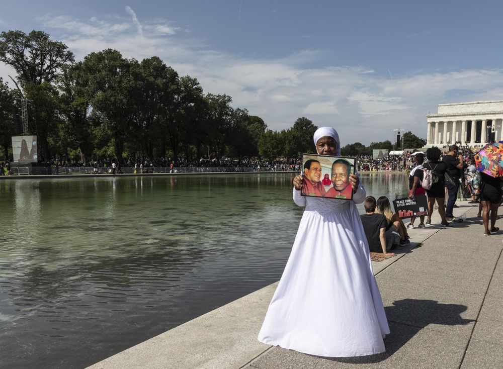 Nun holding photograph at BLM demonstration, Washington, D.C.