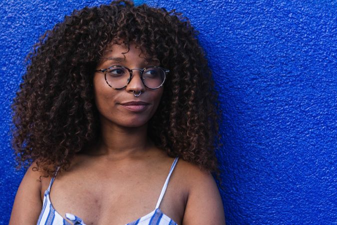 Trendy female against bright wall