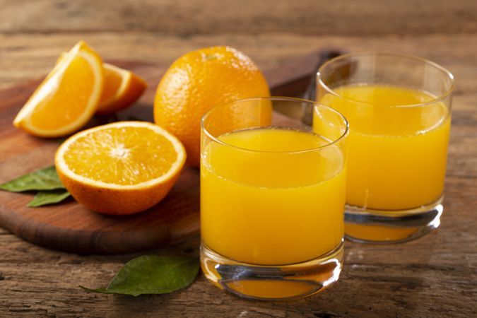 Glass with orange juice on the table.