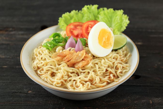 Indomie Rebus or Instant Boiled Noodle on Ceramic Bowl