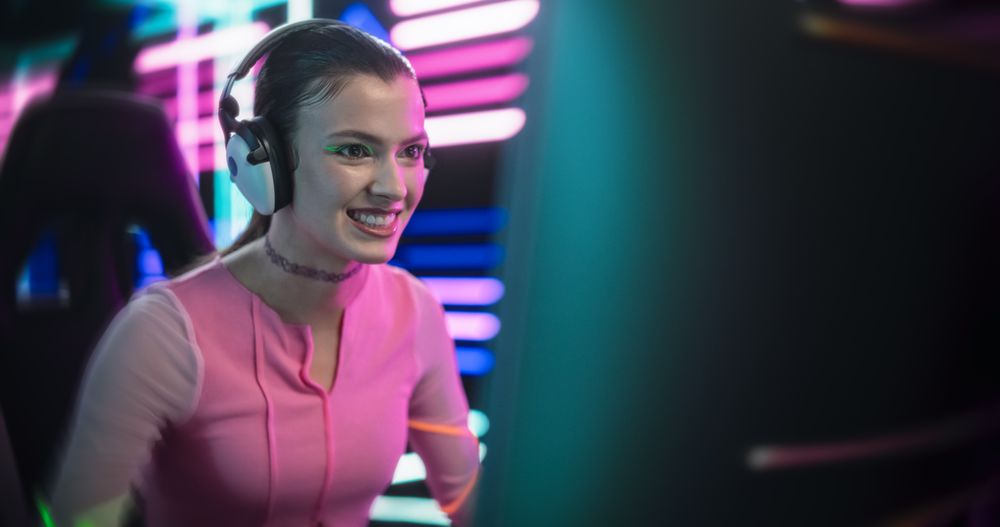 Close Up of a Young Female Playing Online Video Games on a Desktop Computer.