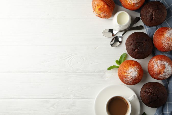 Composition with muffins and cocoa drink on wooden background