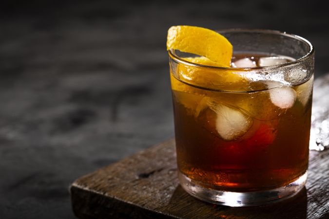 Negroni cocktail with orange, on dark background.
