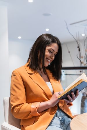 Woman reading book in cafe