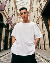 Upshot of man in streetwear surrounded by British Georgian architecture