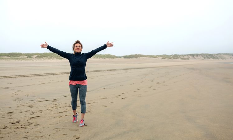 Young woman feeling free on the beach