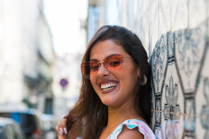 Woman in sunglasses standing on city street