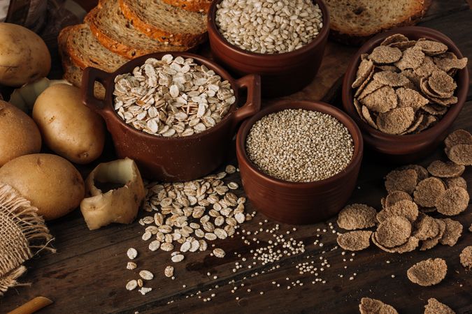 Wholegrain food and freshly baked rye bread on table