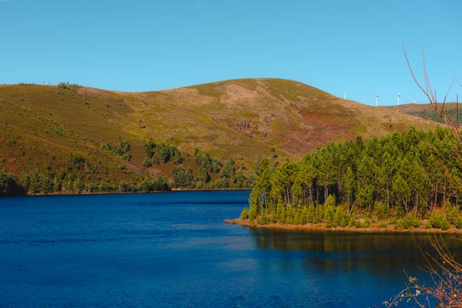 Calm river flowing between green hills