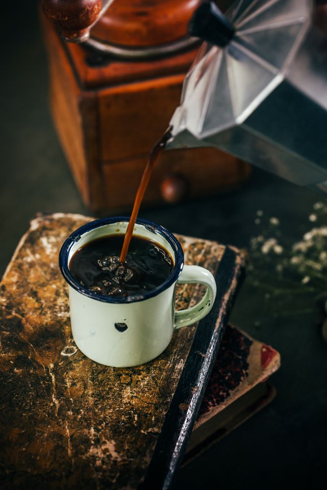 Poring hot coffee in an enamel cup