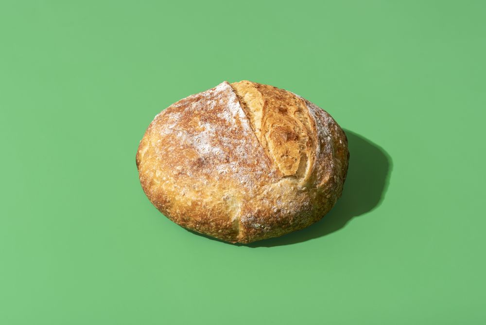 Homemade bread minimalist on a green background
