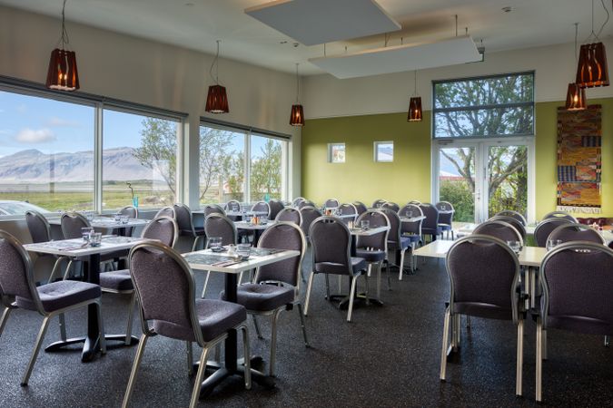 Dinning room with wonderful view of summer mountain landscape from window in hotel