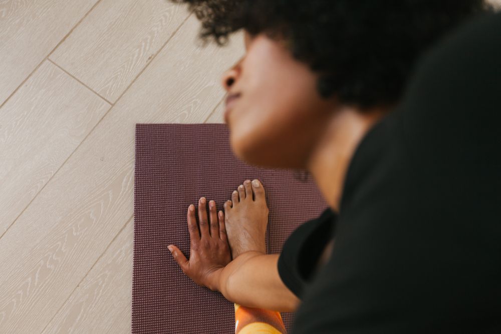 Sportive woman sitting in yoga pose with closed eyes