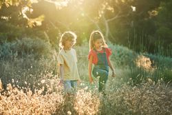 Happy boy and girl walking in countryside