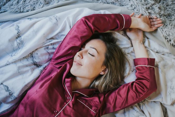 Woman sleeping and smiling in bed