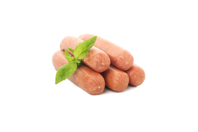 Five sausages in blank room with herb garnish