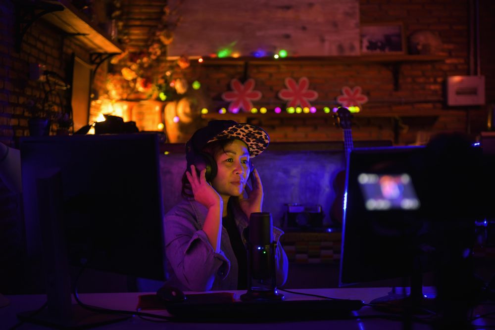 Woman surrounded by cameras and microphone in a podcast studio