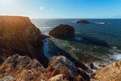 High cliff near water in sunny day